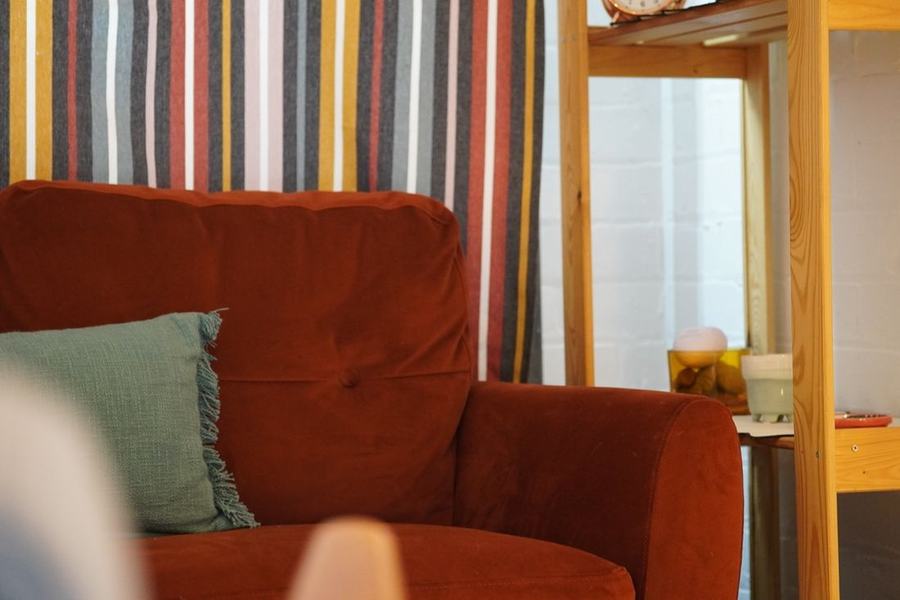 A cosy red armchair in the therapy room