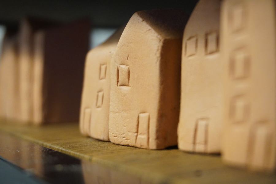 Hand-made clay houses on a shelf in the therapy room